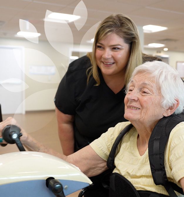 A caregiver helping a resident at Green Acres Nursing and Rehab